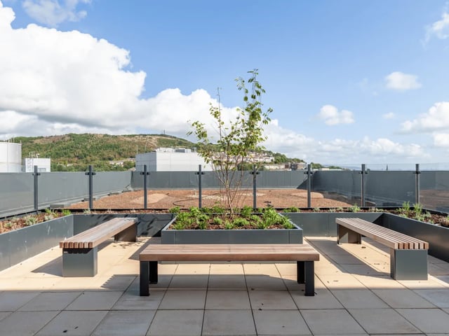 Benches and planters on rooftop patio exterior at Ty Nant in Swansea Student Accommodation