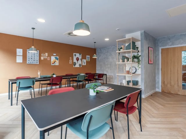Tables chairs corkboard artwork communal area at Ty Nant in Swansea Student Accommodation