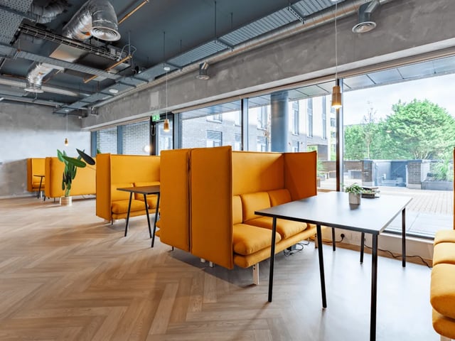 Orange booths with tables communal area at Ty Nant in Swansea Student Accommodation