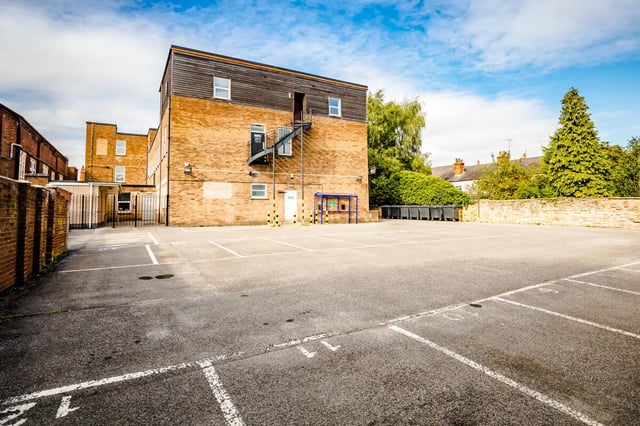 Brick building with parking lot exterior at Crosstrend House in Lincoln Student Accommodation