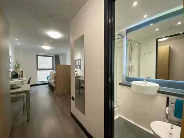 Bed desk shower sink and toilet bathroom at Swanston House in Belfast Student Accommodation