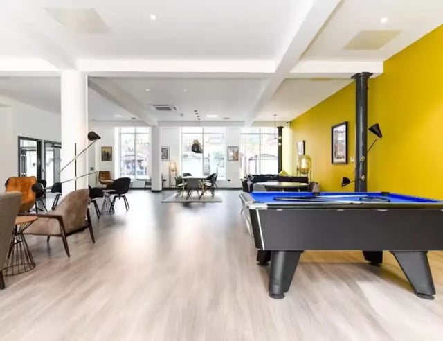 Pool table seating area with yellow wall Common room at Swanston House in Belfast Student Accommodation