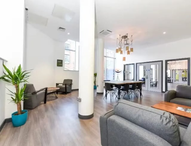 Lounge with seating dining table and plant Common area at Swanston House in Belfast Student Accommodation