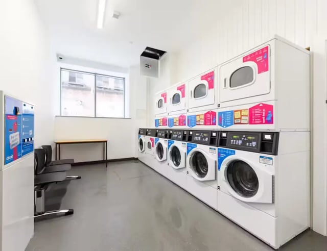 Washing machines dryers seating area laundry room at Swanston House in Belfast Student Accommodation