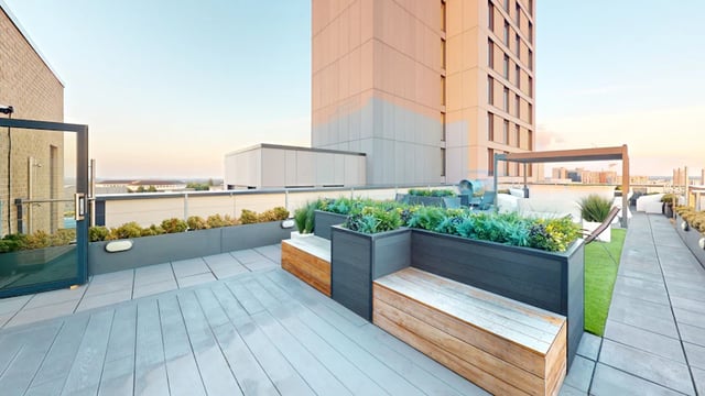 Rooftop with benches plants and seating exterior at 33 Parkside in Coventry Student Accommodation
