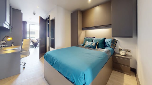 Bed desk chair and alarm clock bedroom at 33 Parkside in Coventry Student Accommodation