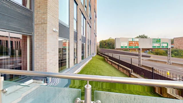 Brick building with grass and highway signs exterior at 33 Parkside in Coventry Student Accommodation