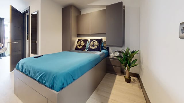 Bed with blue bedding and pillows Bedroom at 33 Parkside in Coventry Student Accommodation