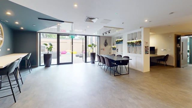 Dining table chairs study desk and laundry room communal area at 33 Parkside in Coventry Student Accommodation