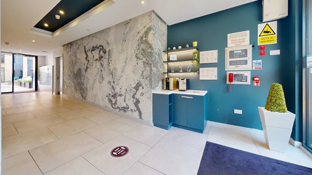 Modern communal area with coffee machine and fire panel at 33 Parkside in Coventry Student Accommodation