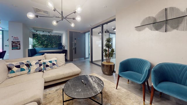 Modern sofa coffee table chairs and plant living room at 33 Parkside in Coventry Student Accommodation