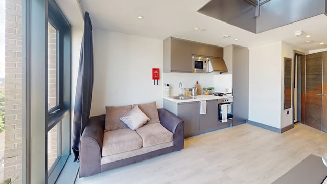 Sofa kitchenette with oven microwave sink living room at 33 Parkside in Coventry Student Accommodation
