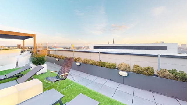 Sun loungers white seating green turf patio exterior at 33 Parkside in Coventry Student Accommodation
