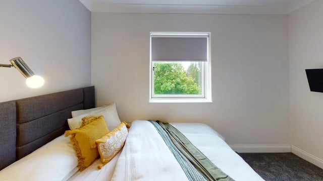 Bed pillows lamp window TV bedroom at Picton Manor in Newcastle Upon Tyne Student Accommodation