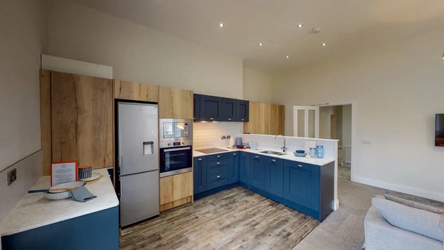 Stainless steel fridge blue cabinets microwave oven kitchen at Picton Manor in Newcastle Upon Tyne Student Accommodation