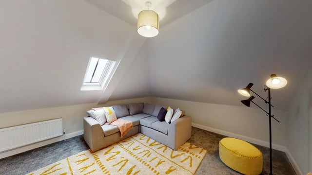 Sofa rug ottoman and floor lamp living room at Picton Manor in Newcastle Upon Tyne Student Accommodation