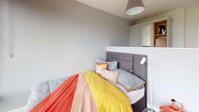 Bed with colorful blankets and pillows bedroom at Picton Manor in Newcastle Upon Tyne Student Accommodation