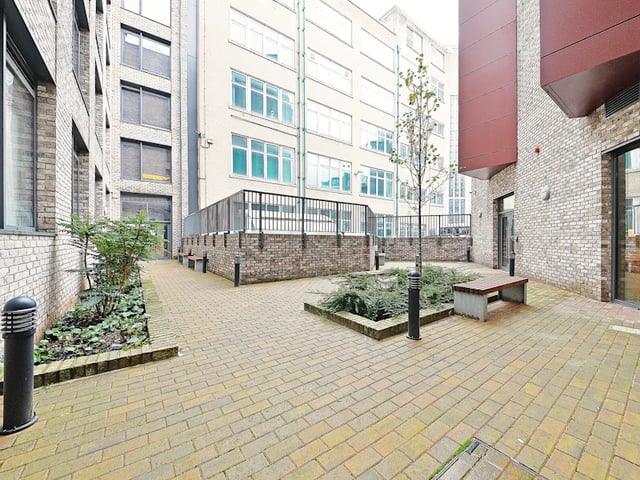 Courtyard with brick paving benches and plants exterior at Fontenoy Apartments in Liverpool Student Accommodation