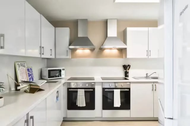 Modern white kitchen with ovens and microwave kitchen at James House in Bath Student Accommodation