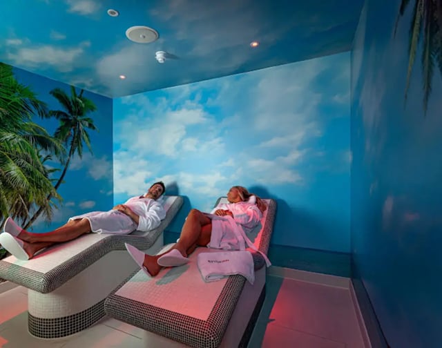 Couple relaxing on lounge chairs spa area at Reynard House in Leicester Student Accommodation