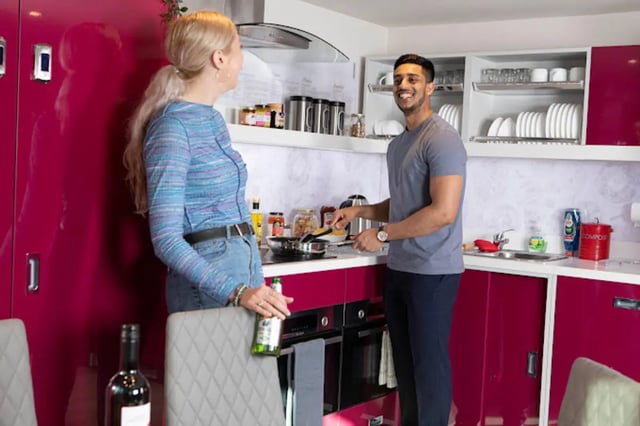 Young couple cooking in modern kitchen kitchen at Reynard House in Leicester Student Accommodation
