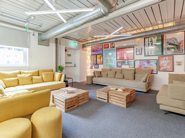 Sofa and wooden coffee tables in living room. at The Glassworks Newcastle in Newcastle Upon Tyne Student Accommodation