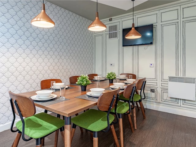 Dining table with chairs and place settings communal dining area at The Glassworks Newcastle in Newcastle Upon Tyne Student Accommodation