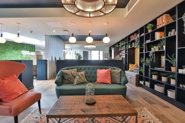 Green sofa with pillows and coffee table living room at St Mary's in Bristol Student Accommodation