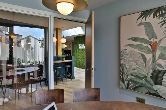 Tables chairs plant wall art common area at St Mary's in Bristol Student Accommodation