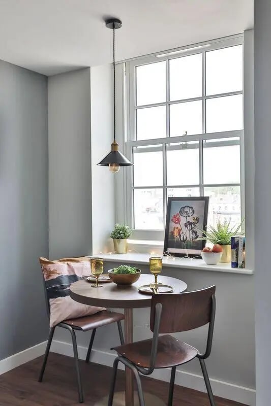 Table chairs window ledge artwork plants dining area at St Mary's in Bristol Student Accommodation