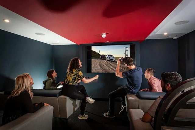 Students playing video games on large screen living room at Study Inn Loughborough - Lemyngton Street in Loughborough Student Accommodation