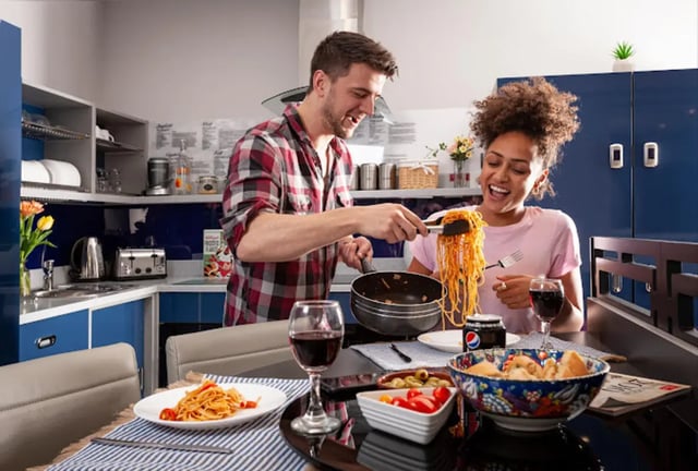 Couple cooking pasta in a modern kitchen at Study Inn Loughborough - Lemyngton Street in Loughborough Student Accommodation