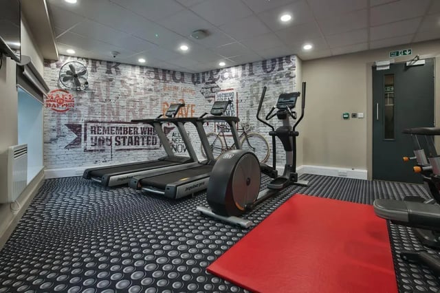 Treadmills elliptical bike wall art fitness area at William & Matthew House in Bristol Student Accommodation