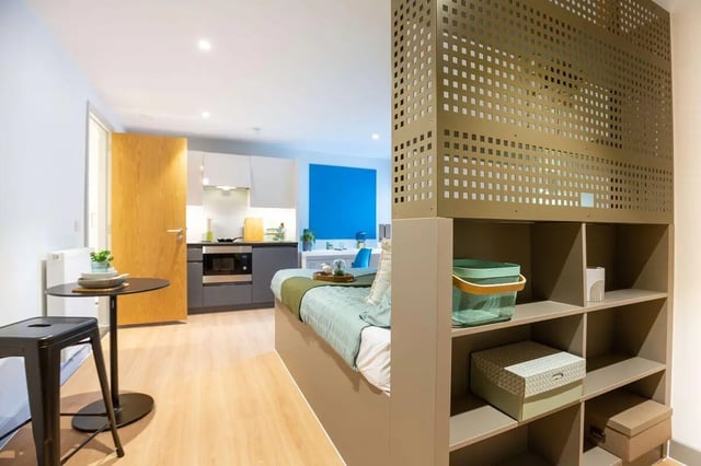 Bed kitchen and shelving unit studio at Market Quarter Studios in Bristol Student Accommodation