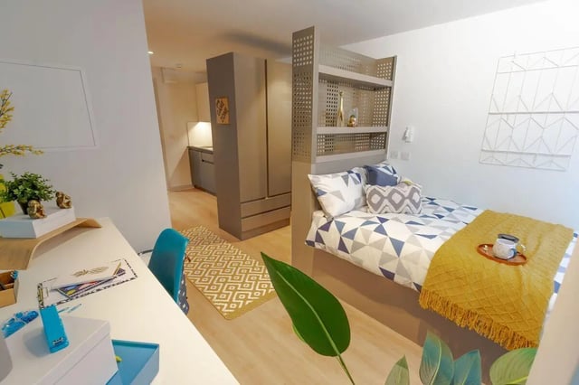 Bed desk kitchen area with modern furniture bedroom at Market Quarter Studios in Bristol Student Accommodation