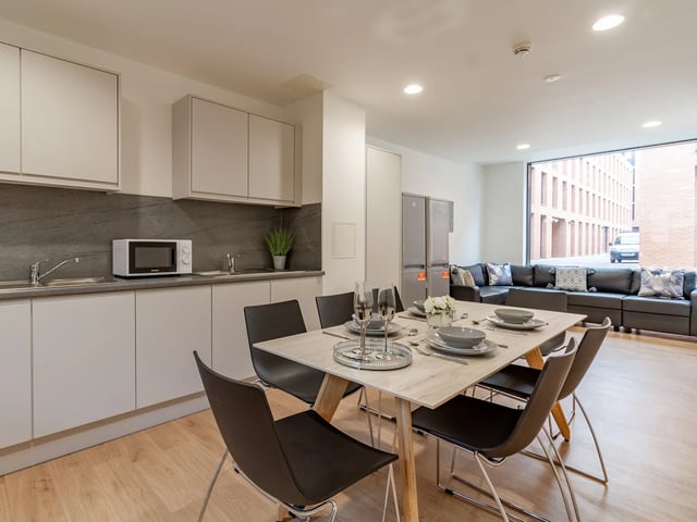Dining table chairs kitchen living room exterior at Straits Village in Nottingham Student Accommodation