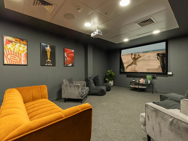 Orange sofa beanbags and projector screen cinema room at Straits Village in Nottingham Student Accommodation
