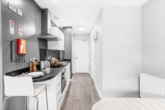 Countertops cabinets appliances and a bar stool kitchen at Northgate House in Derby Student Accommodation