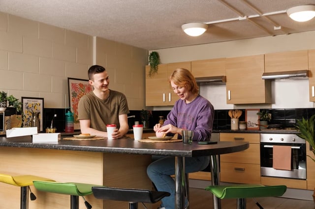Students at kitchen counter with breakfast and coffee kitchen at Spring Gardens in Aberdeen Student Accommodation