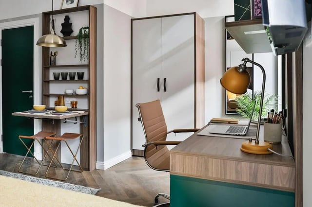 Desk chair folding table shelves lamp laptop study area at South Bridge in Edinburgh Student Accommodation