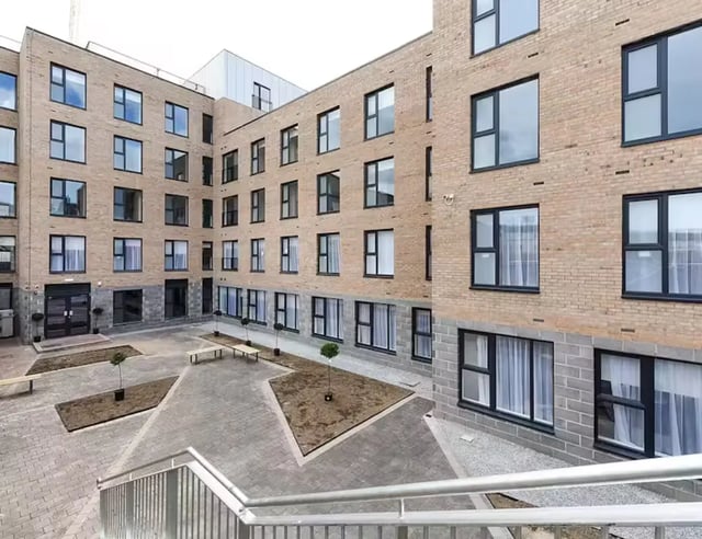 Courtyard with benches and trees exterior at Pittodrie Street in Aberdeen Student Accommodation