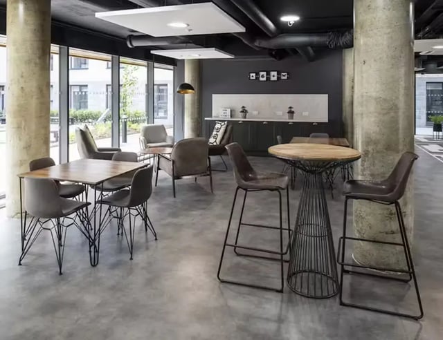 Dining tables chairs bar counter kitchen area communal space at Pittodrie Street in Aberdeen Student Accommodation