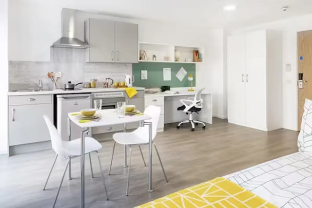 Kitchenette dining area desk with chair and wardrobe studio room at Pittodrie Street in Aberdeen Student Accommodation