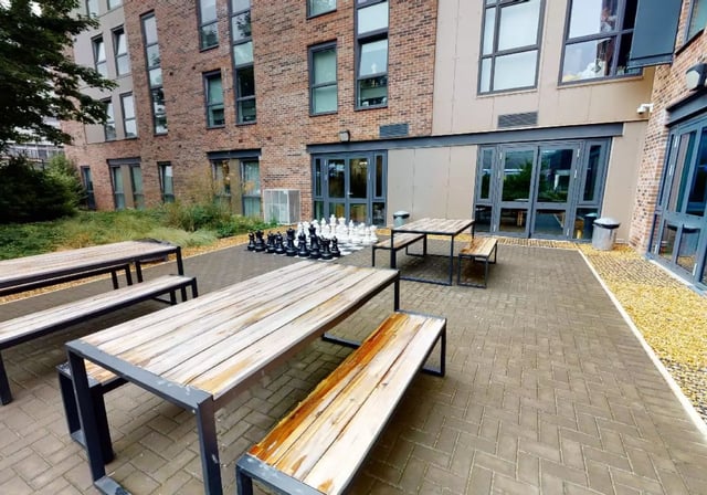 Outdoor seating tables and giant chess set courtyard at iQ Collingwood in Newcastle Upon Tyne Student Accommodation