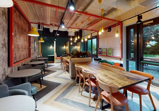 Communal dining tables and chairs lounge area at iQ Collingwood in Newcastle Upon Tyne Student Accommodation