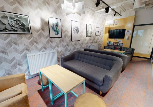 Sofas tables and artwork in a lounge area at iQ Collingwood in Newcastle Upon Tyne Student Accommodation