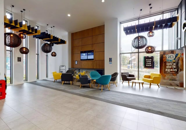 Chairs, table, television, banners, lights, lounge at iQ Century Square in Sheffield Student Accommodation