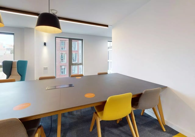 Large table chairs and windows study area at iQ Century Square in Sheffield Student Accommodation
