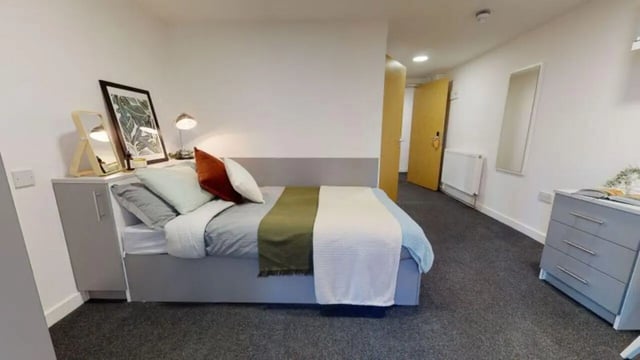 Bed with pillows and dresser Bedroom at iQ Century Square in Sheffield Student Accommodation