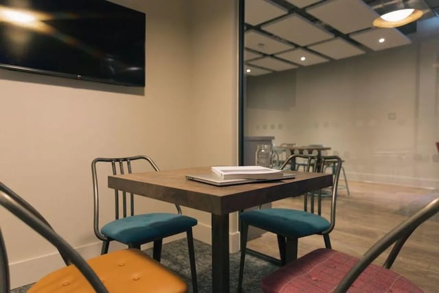 Table chairs laptop book glass common area at Picturehouse Apartments in Exeter Student Accommodation